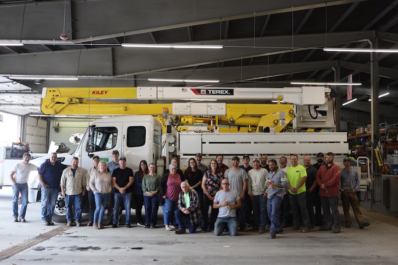 The staff of Washington Electric Co-op in front of a bucket truck